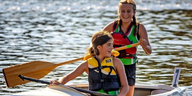 Two girls paddling a sprint canoe